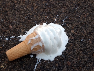 vanilla ice cream cone dropped on street curb